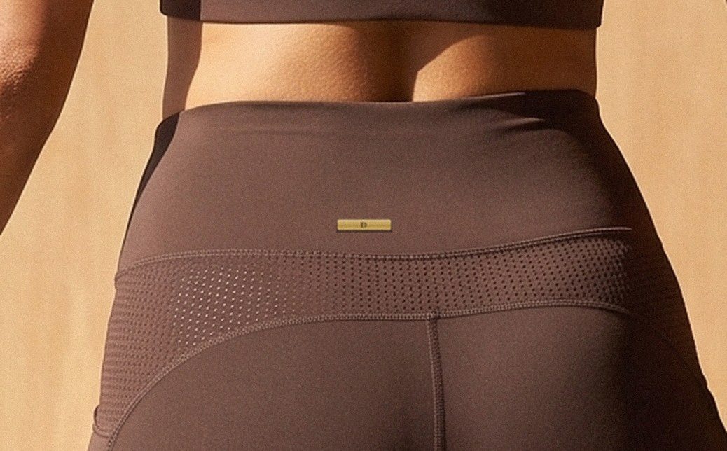 Close up of the D-Bar, a small brushed champagne bar at the back of the waistband
